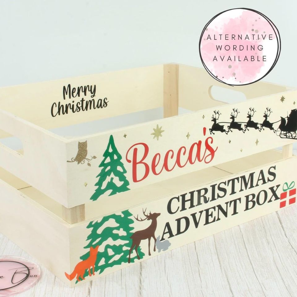 Wooden crate lettered “Becca’s Christmas Advent Box” with green trees, a deer and Santa’s sleigh