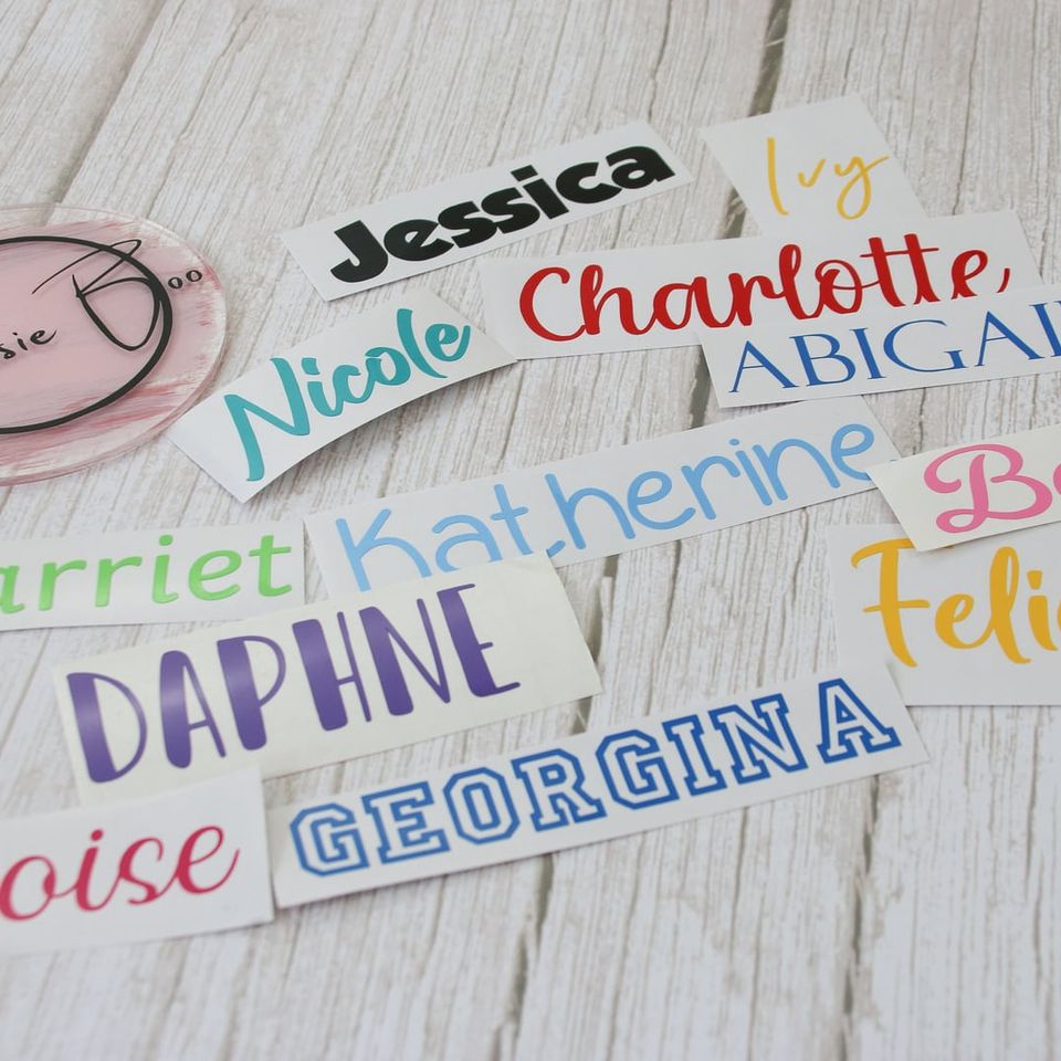 A spread of vinyl name labels in different fonts and colours: Jessica, Charlotte, Daphne, Georgina and more