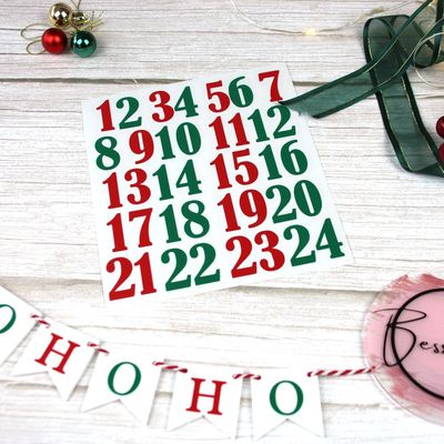 Red and green vinyl advent numbers 1 to 24 beside “Ho Ho Ho” bunting