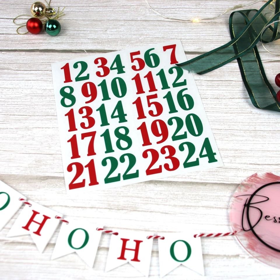 Red and green vinyl advent numbers 1 to 24 beside “Ho Ho Ho” bunting
