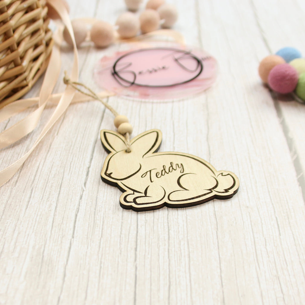 Easter basket wooden tag to be used as an Easter Decoration. The tag is in the shape of a bunny made from 3mm Plywood beautifully cut by laser. The item includes personalisation options, such as the name of a child. The image says &#39;Teddy&#39;.